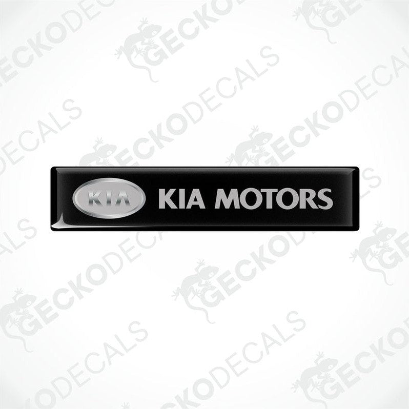 Black rectangular car decals with 'KIA MOTORS' written in white text.