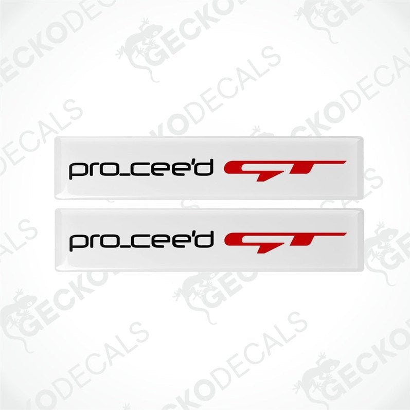 Two white vinyl stickers with the text 'PRO CEED GT' in red and black placed against a white background.