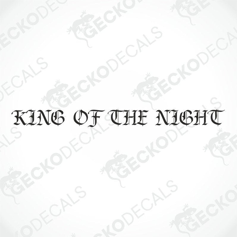A gray truck with a 'KING OF THE NIGHT' decal on the windshield.
