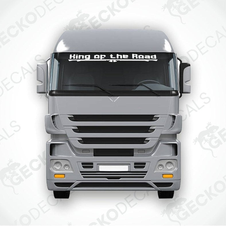 A die cut decal with the text 'King of the Road' displayed on the windshield of a gray truck.