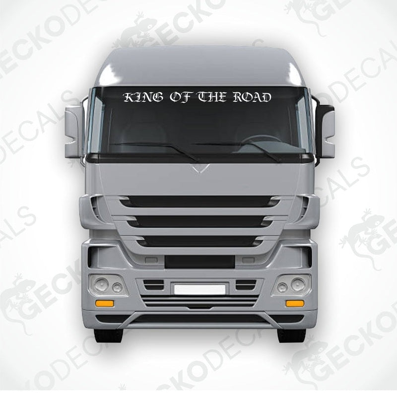 A die cut decal with the text 'KING OF THE ROAD' displayed on the front of a gray truck's windscreen.