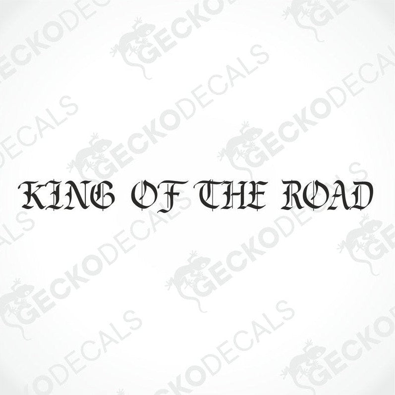 A die cut decal with the text 'KING OF THE ROAD' displayed on the front of a gray truck's windscreen.