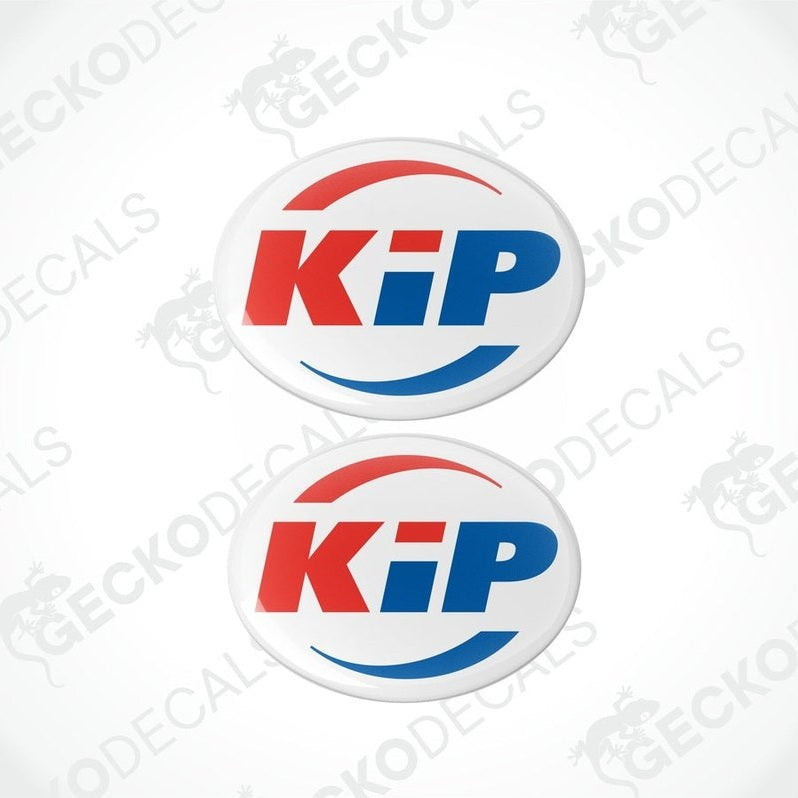 Two round decals with the letters 'KiP' in red and blue on a white background, with a logo that includes a mountain and pine tree graphic.