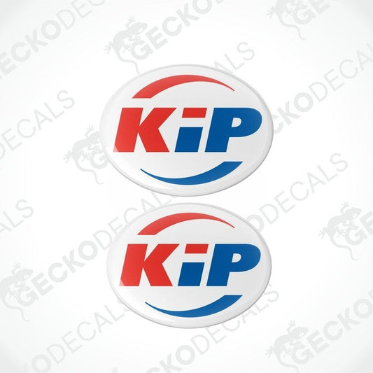 Two round decals with the letters 'KiP' in red and blue on a white background, with a logo that includes a mountain and pine tree graphic.