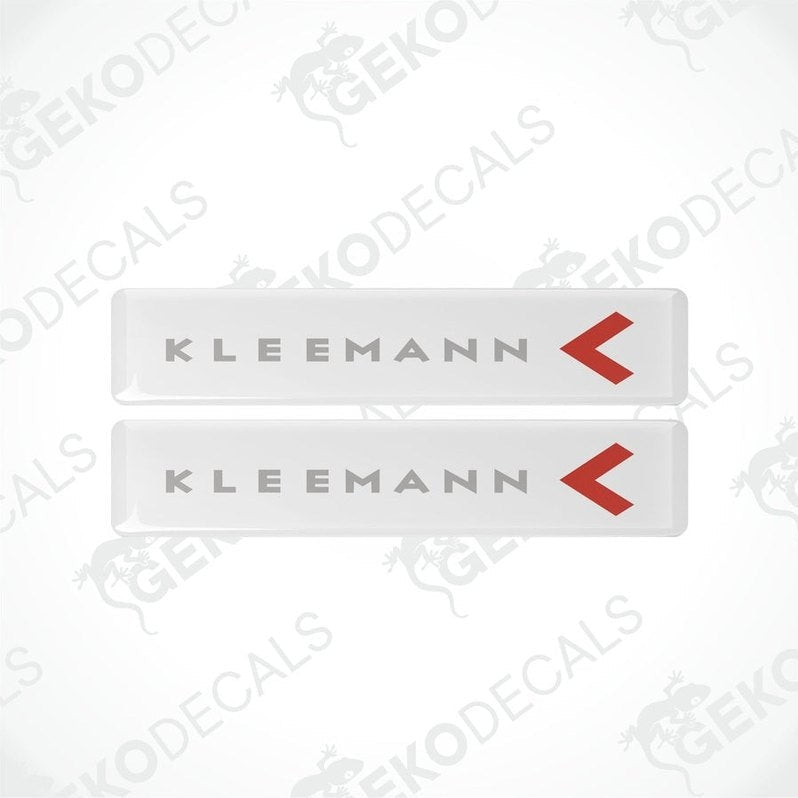 Two white vinyl decals with the text 'KLEEMANN' and a red arrow symbol on them.