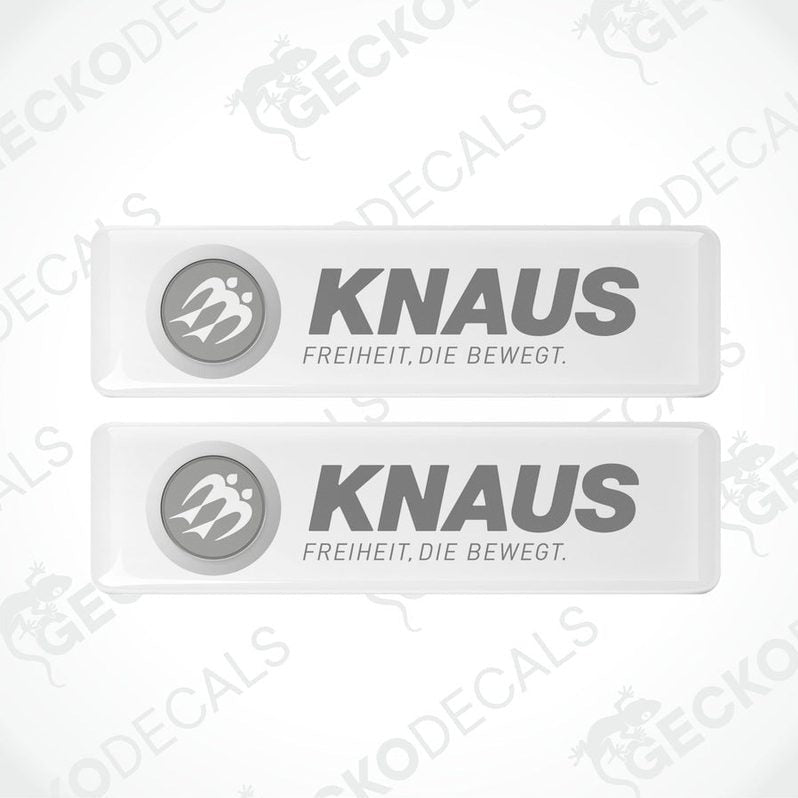 Two white rectangular epoxy decals with the text 'KNAUS FREIHEIT. DIE BEWEGT.' and the logo of KNAUS brand.