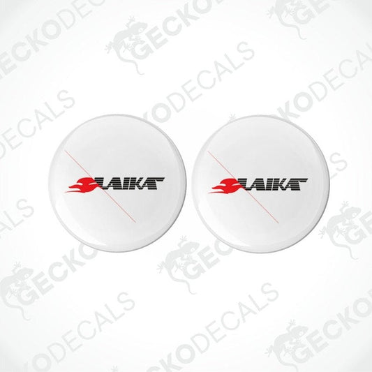 Two white round decals with the LAIKA brand logo in red and black, placed on a white background.