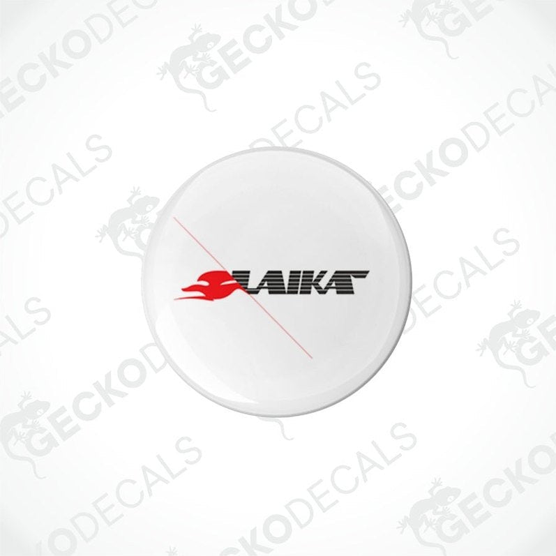 Two white round decals with the LAIKA brand logo in red and black, placed on a white background.