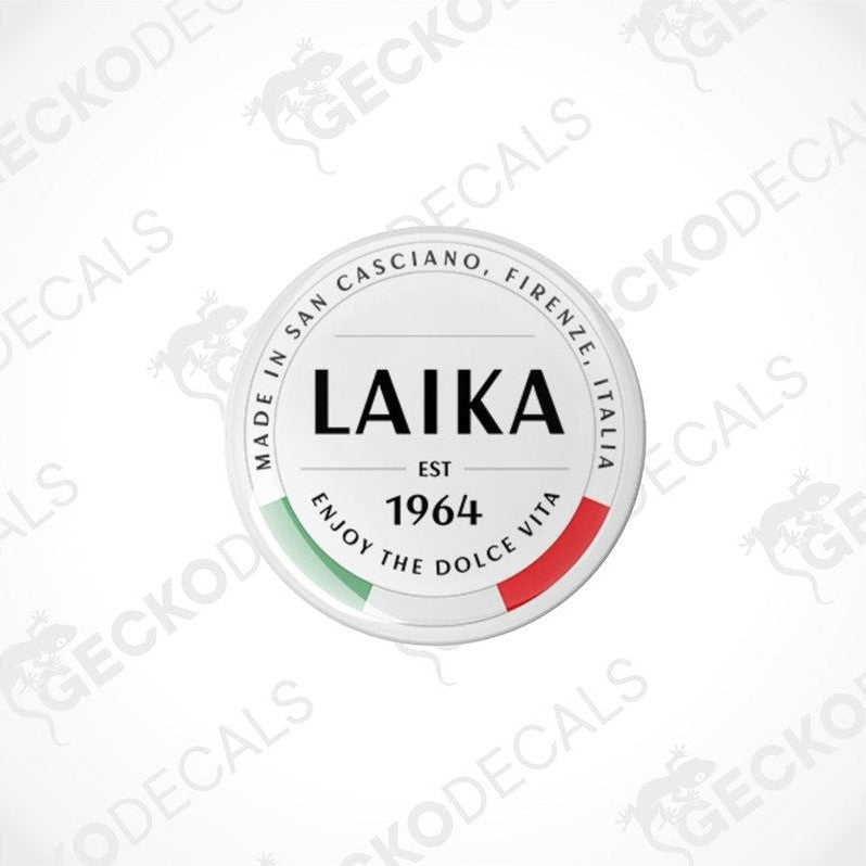 Two round white vinyl decals with 'LAika' branding and red and green accents, indicating they are from San Cassiano, Tuscany, Italy.
