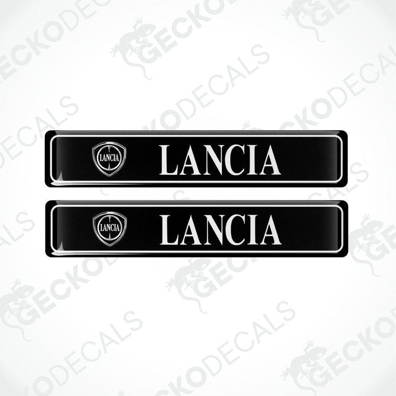 Two black vinyl stickers with 'LANCIA' text and a logo, placed against a white background.