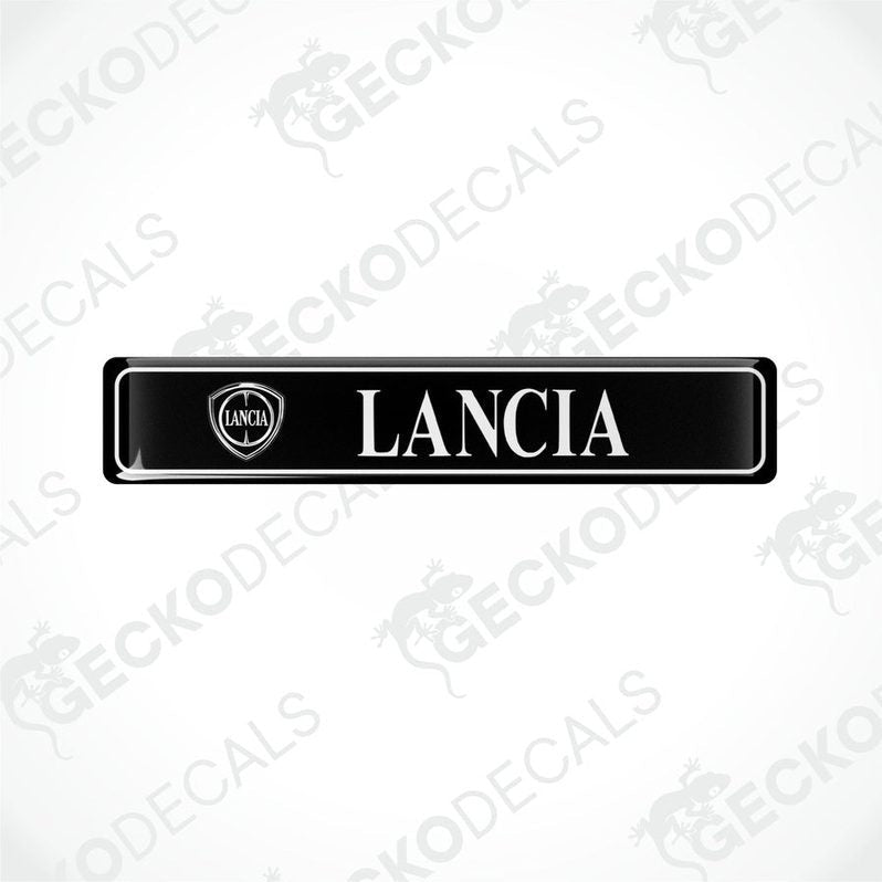Black vinyl stickers with 'LANCIA' text and a logo, placed against a white background.
