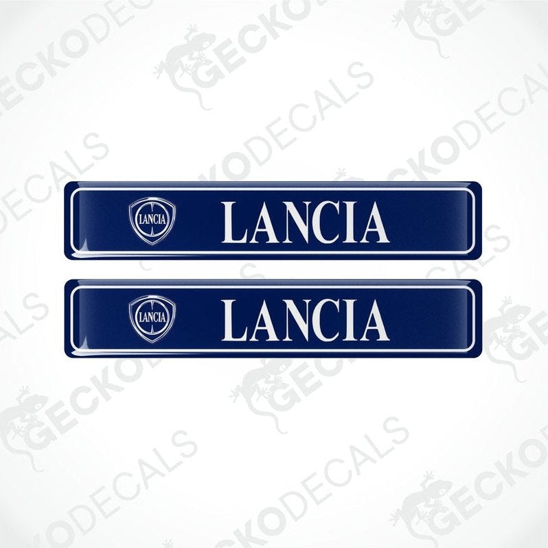 Two blue vinyl stickers with 'LANCIA' text and a logo, placed against a white background.