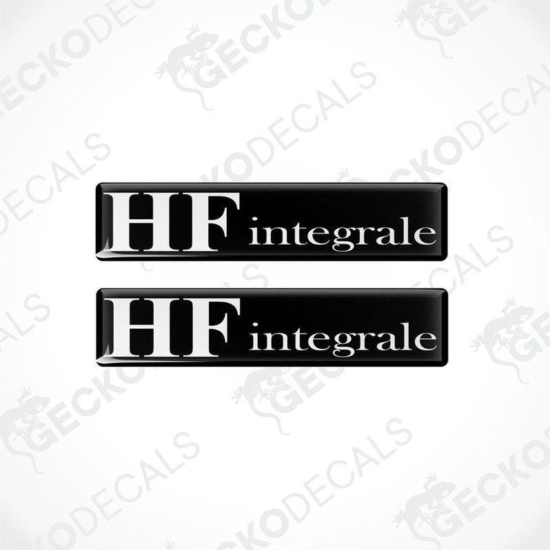 Two rectangular black vinyl decals with the word 'LANCIA HF INTEGRALE' written in white letters.