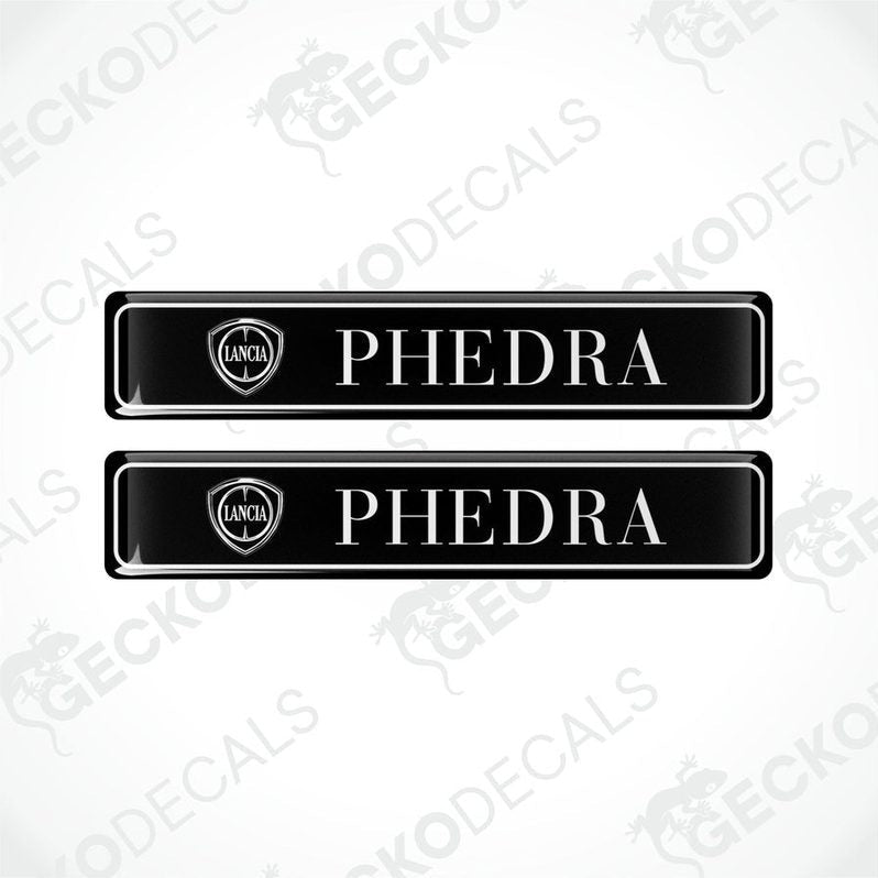 Two black vinyl stickers with the word 'LANCIA' and 'PHEDRA' branded on them, placed against a white background with the GeckoDecals logo.
