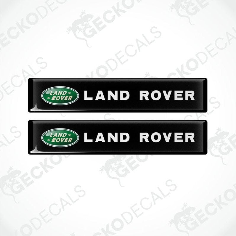 Two black vinyl stickers with the Land Rover brand logo in green.