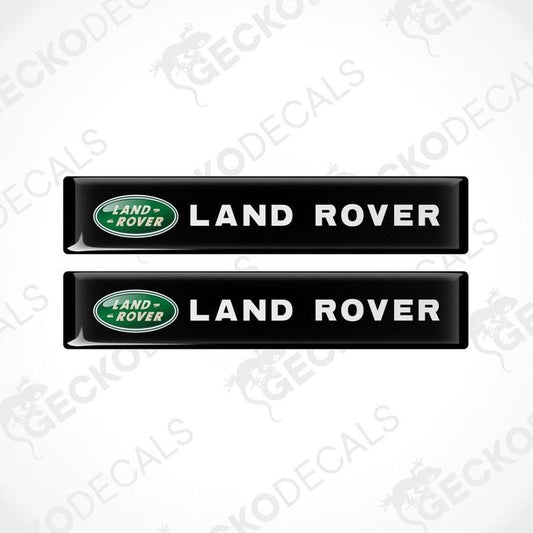 Two black vinyl stickers with the Land Rover brand logo in green.
