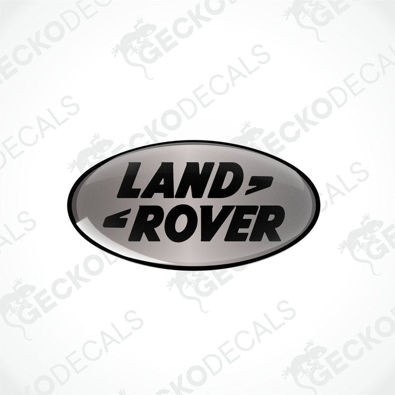  Oval-shaped black and silver vinyl decals with the text 'LAND ROVER' on them.