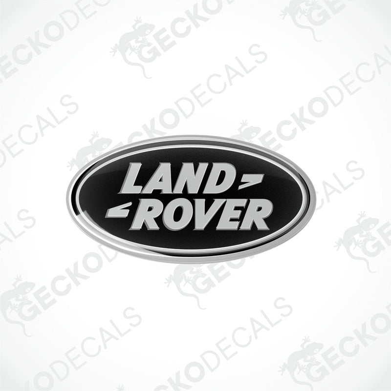 Oval-shaped black and silver car decals with the text 'LAND ROVER' on them.