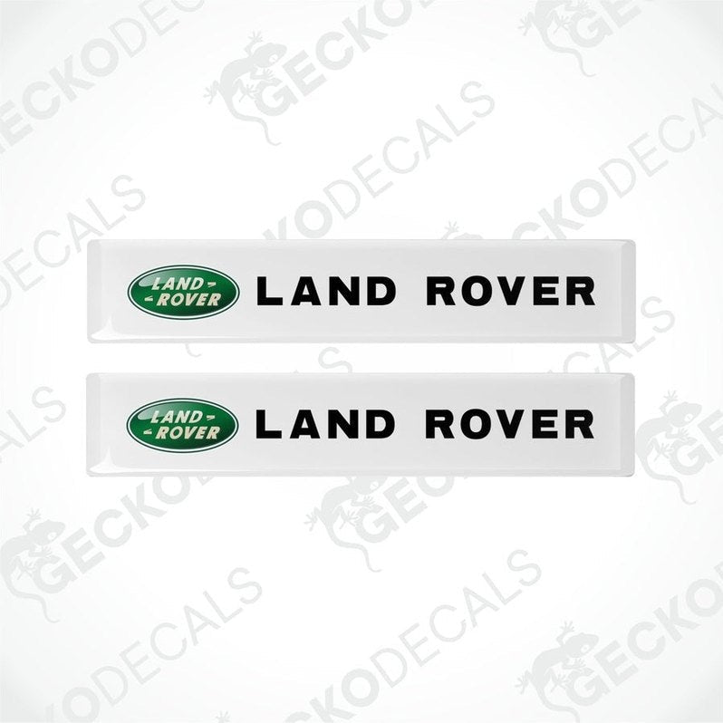 Two white vinyl stickers with the Land Rover brand logo in green.