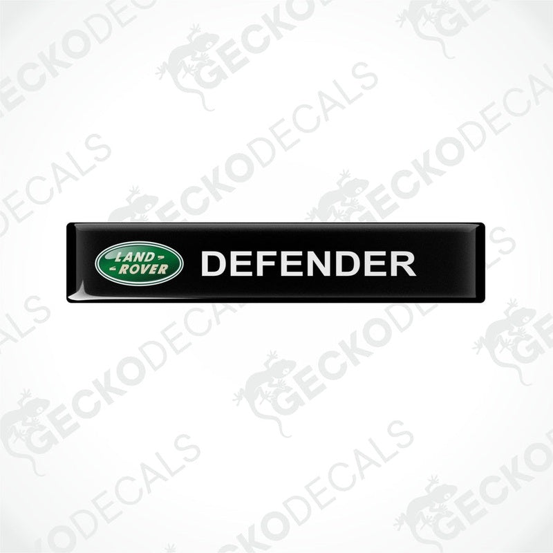 Black vinyl decals with the text 'DEFENDER' and the Land Rover logo in green.