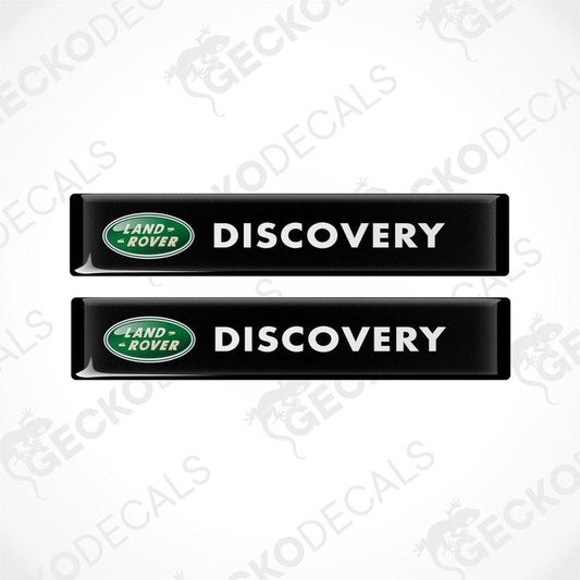 Two black vinyl decals with the text 'DISCOVERY' and the Land Rover logo in green and white.