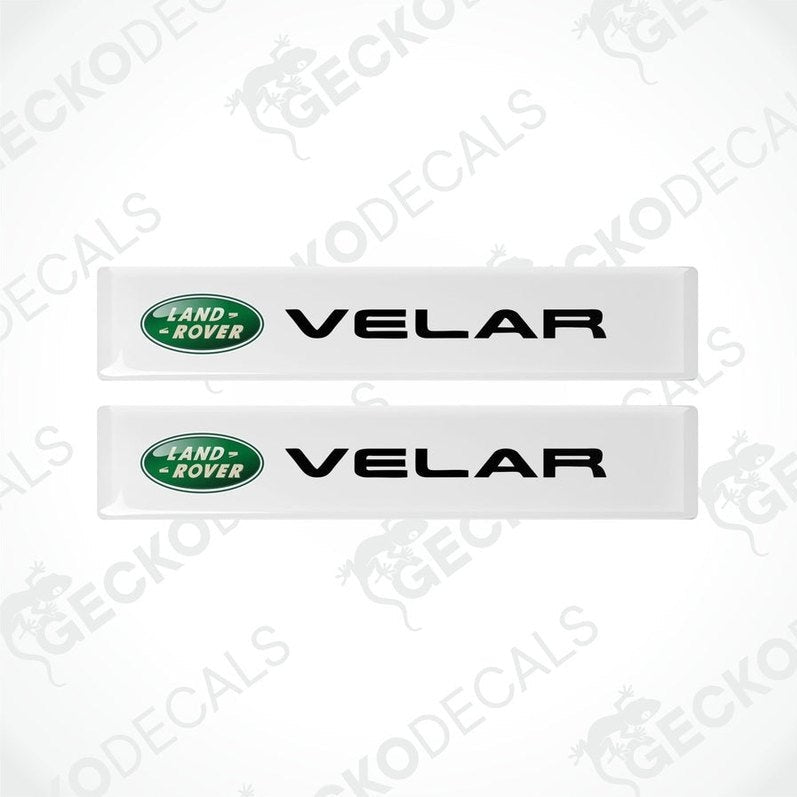 Two white vinyl stickers with the Land Rover Velar brand logo.