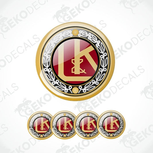 A set of four gold, red, and black vinyl stickers with a geometric design and the letter 'L' in the center, representing the brand LAURIN & KLEMENT.