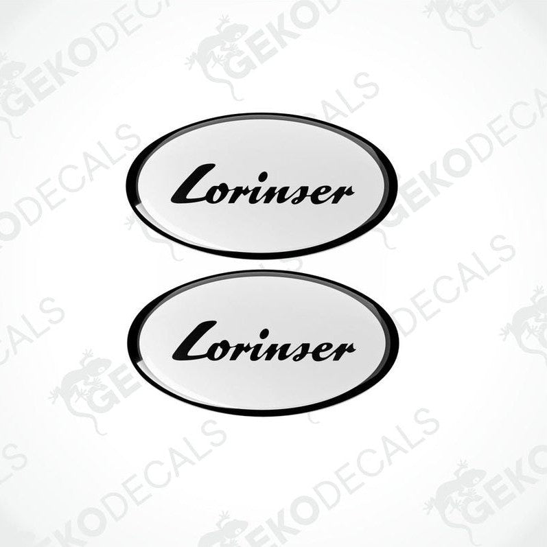 Two white oval-shaped vinyl decals with the black text 'Lorinser' on them.