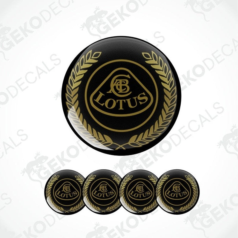 A set of four black and gold vinyl decals with the LOTUS logo applied on a black background.