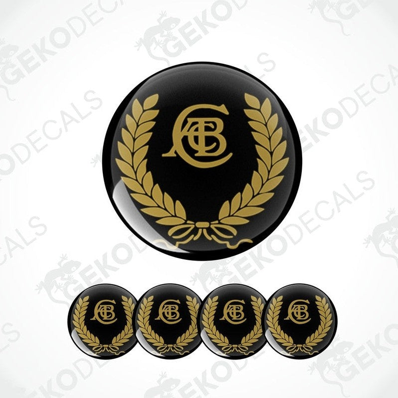 A set of four black vinyl stickers with a gold and white laurel wreath design and the letter 'C' in the center, placed on a white background.