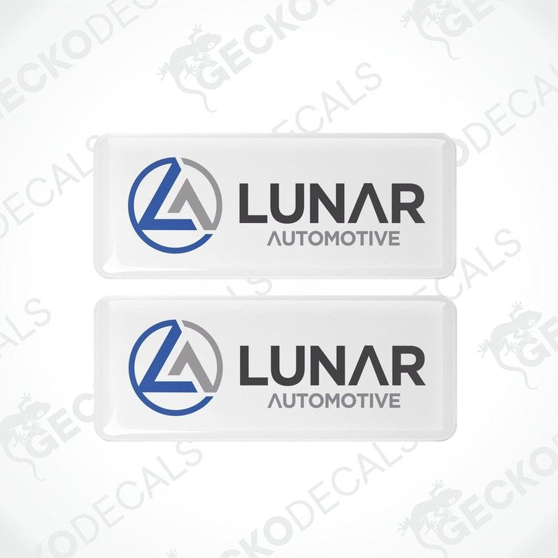 Two white vinyl stickers with a blue and grey Lunar Automotive logo, placed on a white background.