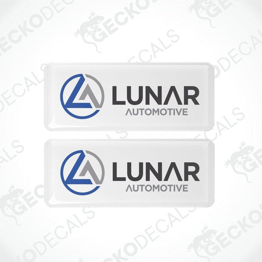 Two white vinyl stickers with a blue and grey Lunar Automotive logo, placed on a white background.