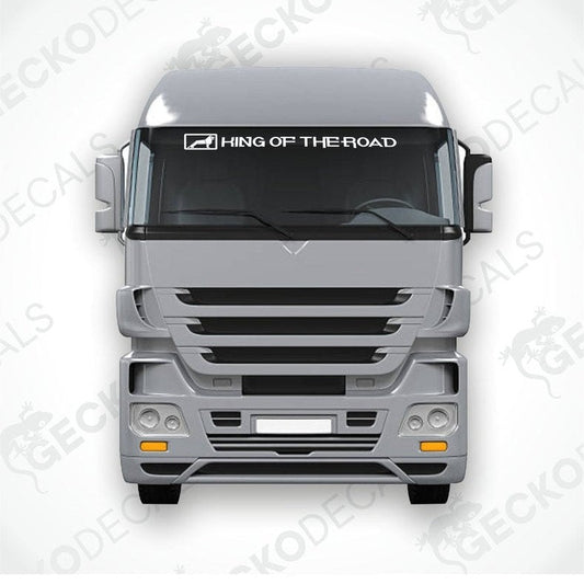 A front view of a gray truck with a die cut sticker on the windscreen that reads 'K I N G O F T H E R O A D'.