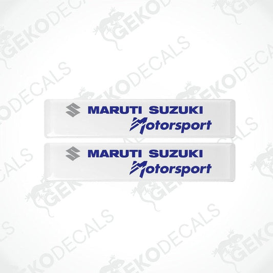 Two white vinyl stickers with the MARUTI SUZUKI logo and the slogan 'MOTORSPORT' printed in blue .