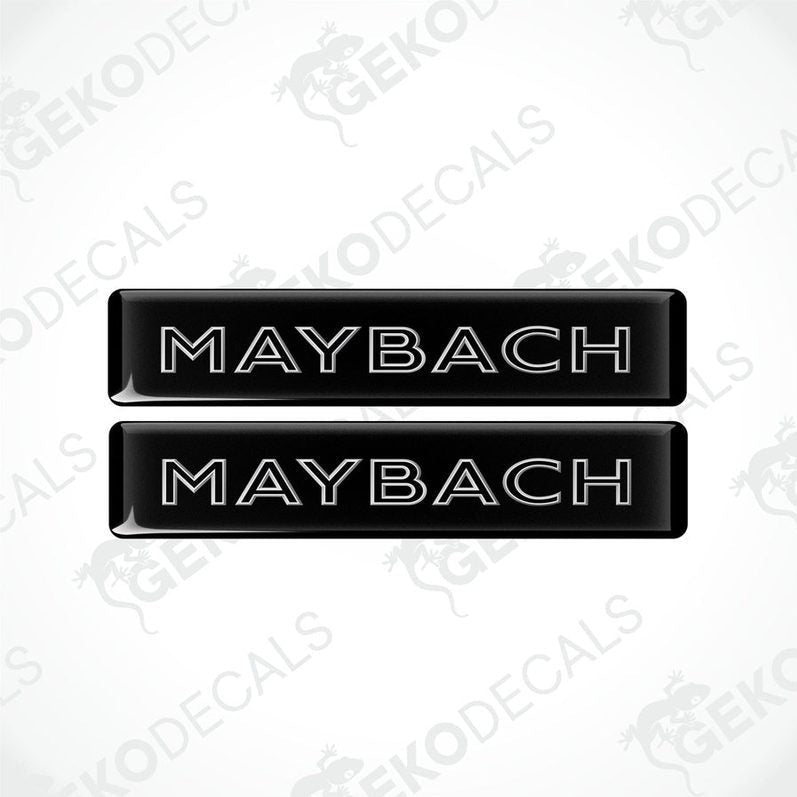 Two rectangular black vehicle decals with the text 'MAYBACH' in capital letters