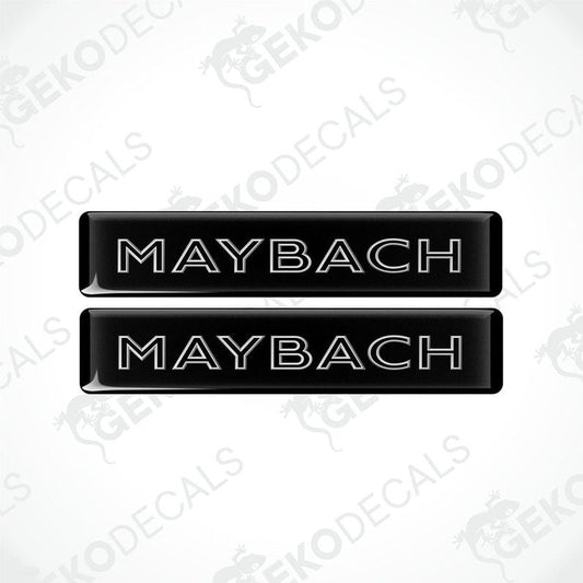 Two rectangular black vehicle decals with the text 'MAYBACH' in capital letters