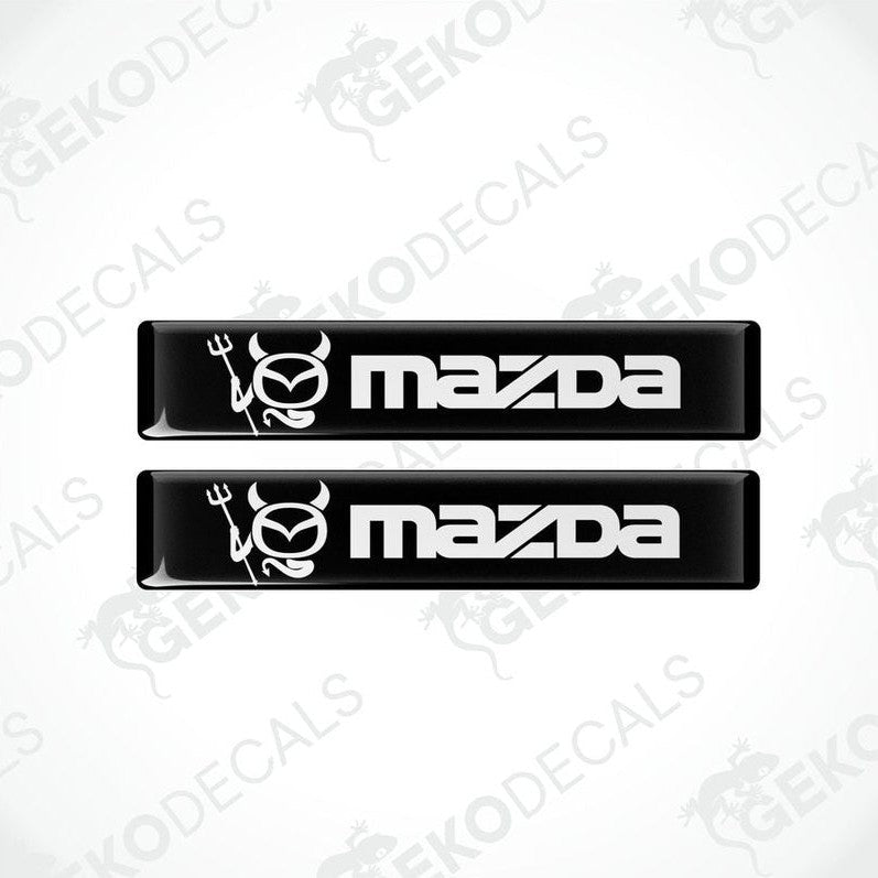 Two black and white vinyl decals with the Mazda logo.