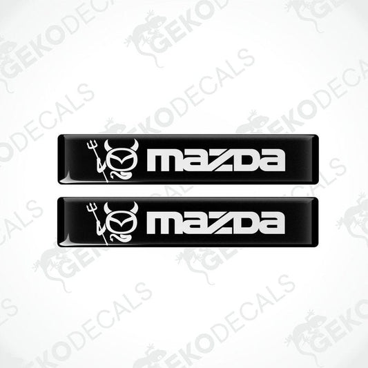 Two black and white vinyl decals with the Mazda logo.