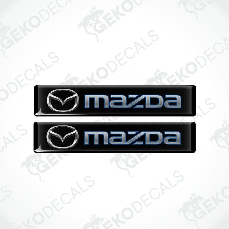 Two black and blue vinyl decals with the Mazda logo
