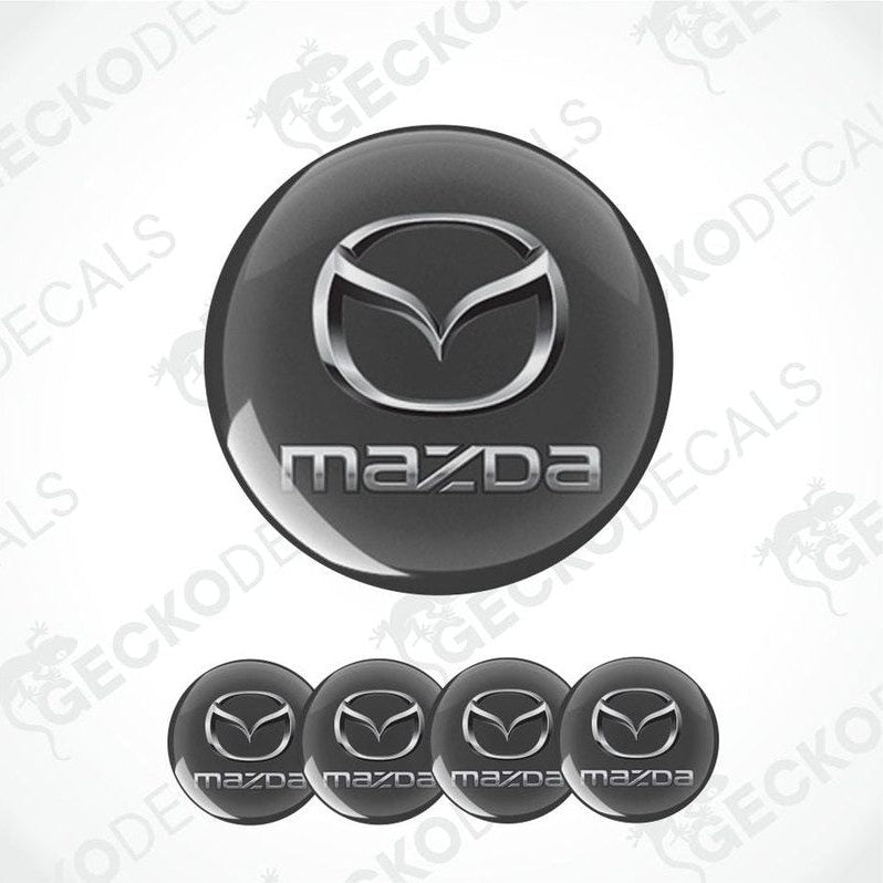 Mazda logo on a black background with multiple instances of the logo.