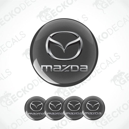 Mazda logo on a black background with multiple instances of the logo.