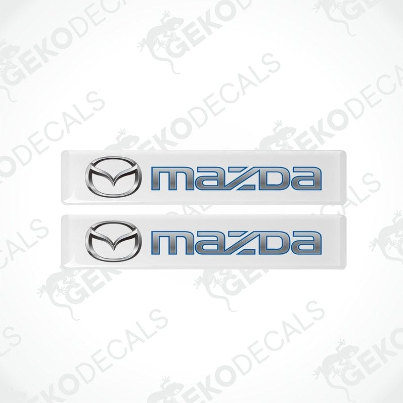 Two white and blue vinyl decals with the Mazda logo