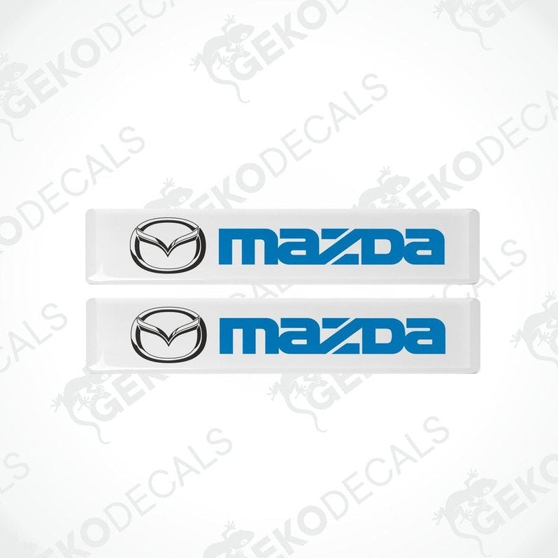 Two white and blue vinyl decals with the Mazda logo