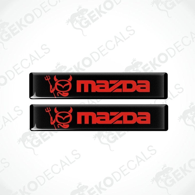  Two red and black vinyl decals with the Mazda logo.
