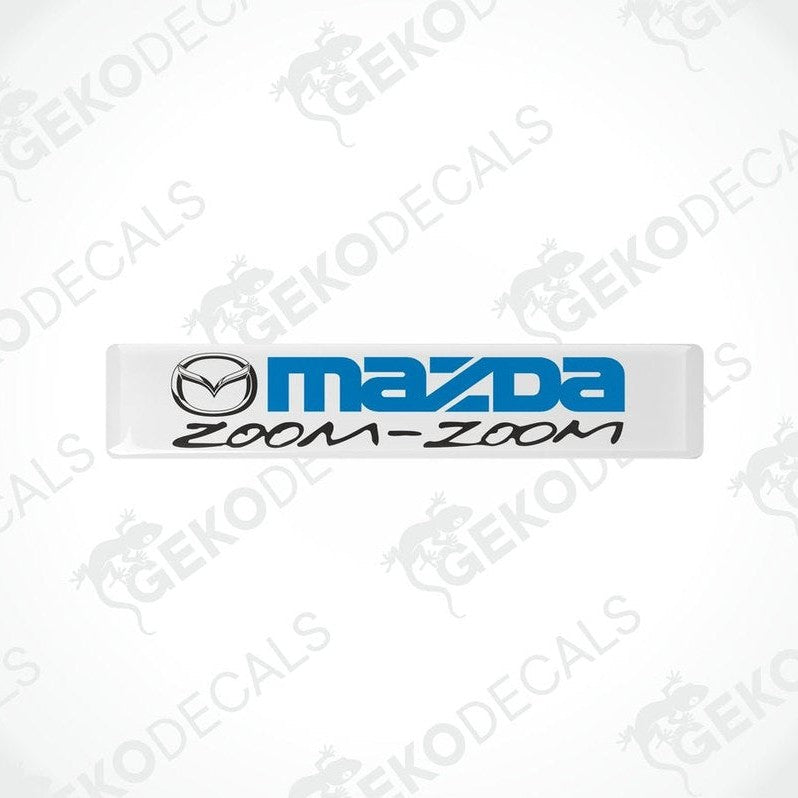 White vinyl stickers with the text 'MAZDA ZOOM-ZOOM' in blue.