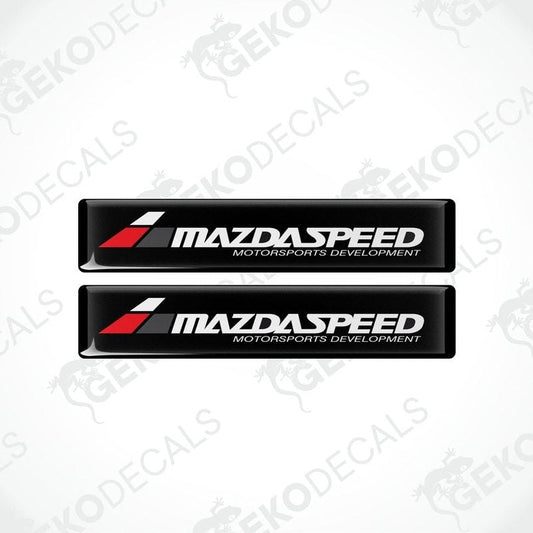 Two black vinyl stickers with the MAZDASPEED MOTORSPORTS DEVELOPMENT logo in white and red.