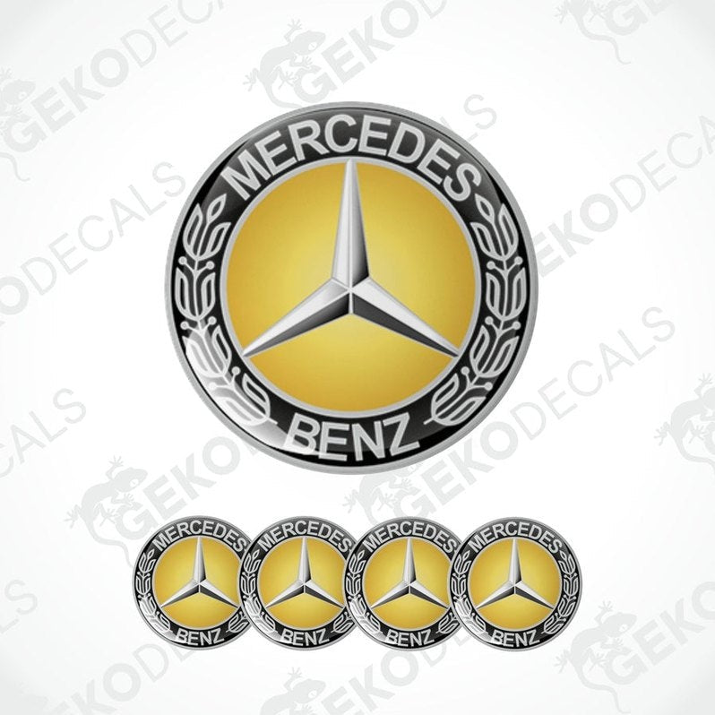 A set of four vinyl decals with a polyurethane coating featuring the Mercedes-Benz logo in gold, black, and silver colors.