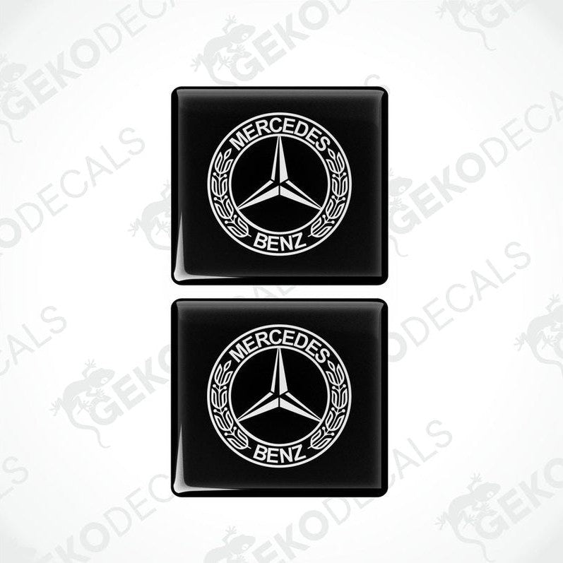 Two black square decals with the Mercedes-Benz logo in white.