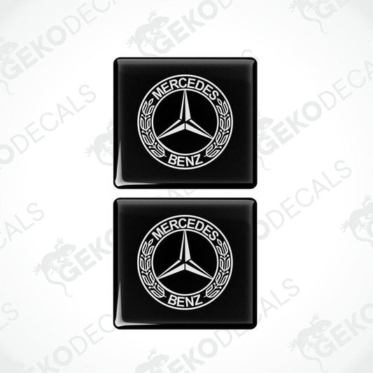 Two black square decals with the Mercedes-Benz logo in white.