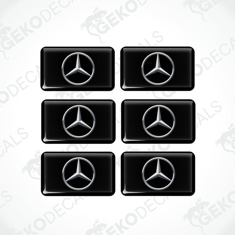 A set of six black vinyl stickers with a Mercedes-Benz logo on each.